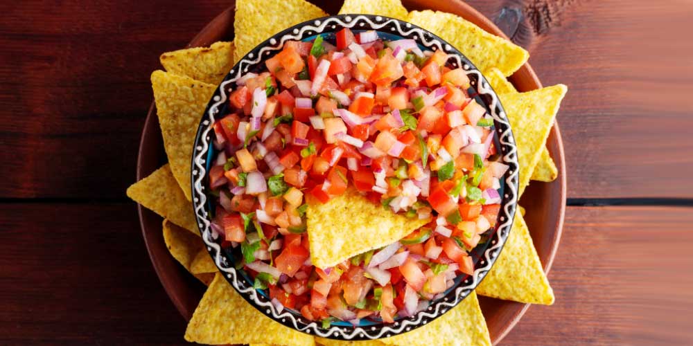 Fresh pico de gallo salsa served with tortilla chips, a Healthy Choices recipe