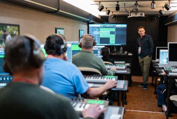 Wide view of a Beatcraft session with participants at keyboards and a facilitator near the back wall