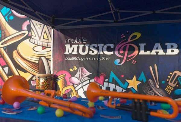 Close-up of the Mobile Music Lab trailer mural featuring the logo and colorful instrument artwork